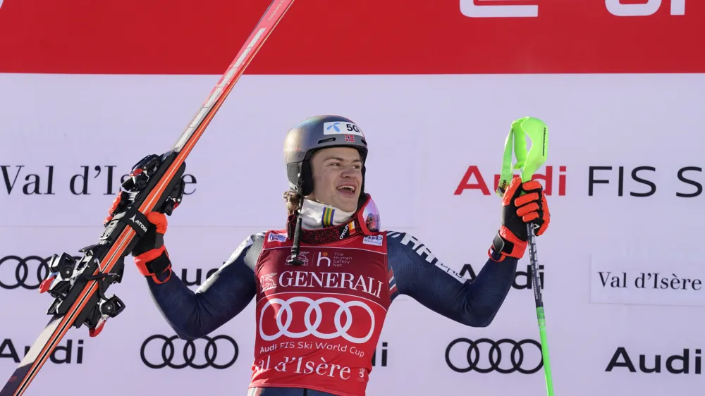 Norway's Lucas Braathen celebrates on the podium after winning an alpine ski, men's World Cup slalom, in Val D'Isere, France, Sunday, Dec.11, 2022. (AP Photo/Giovanni Auletta)