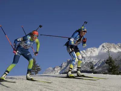 Annamarija Lampic of Slovenia, left, and Olena Bilosiuk of Ukraine compete during the women 7.5km sprint competition at the Biathlon World Cup race in Hochfilzen, Austria, Thursday, Dec. 8, 2022. (AP Photo/Andreas Schaad)