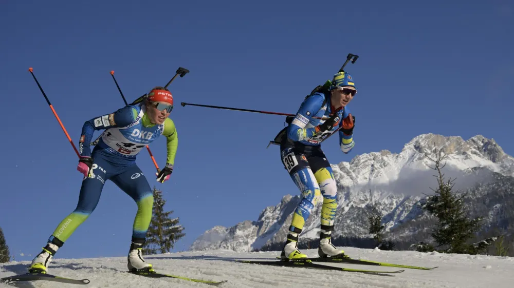 Annamarija Lampic of Slovenia, left, and Olena Bilosiuk of Ukraine compete during the women 7.5km sprint competition at the Biathlon World Cup race in Hochfilzen, Austria, Thursday, Dec. 8, 2022. (AP Photo/Andreas Schaad)