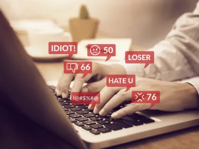 ﻿cyber bullying concept. people using notebook computer laptop for social media interactions with notification icons of hate speech and mean comment in social network