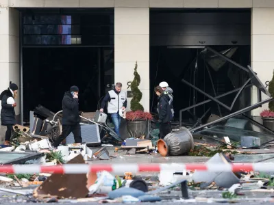 Emergency services work on a street outside a hotel after a burst and leak of the AquaDom aquarium in central Berlin near Alexanderplatz, with water poured out onto the street, in Berlin, Germany, December 16, 2022. REUTERS/Michele Tantussi