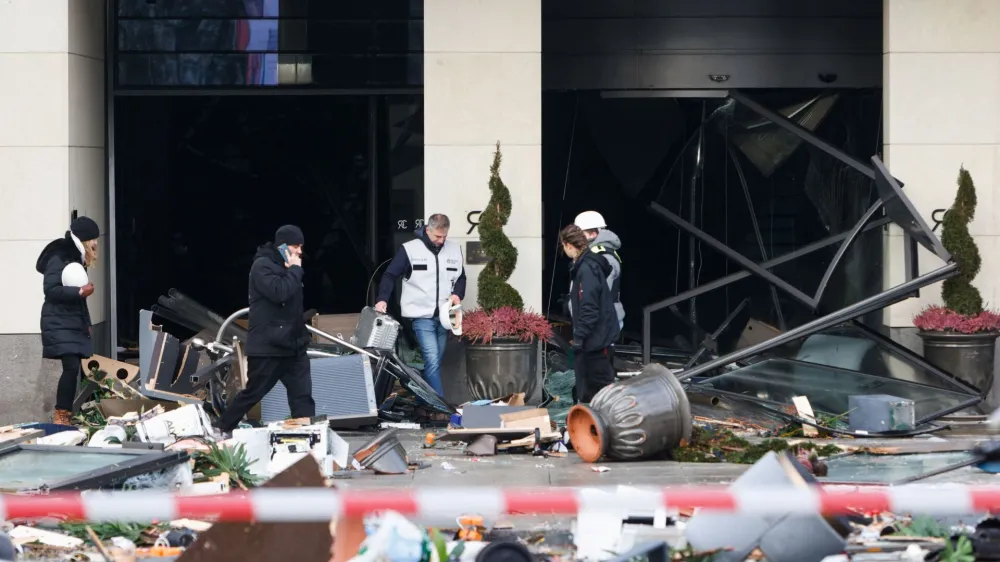 Emergency services work on a street outside a hotel after a burst and leak of the AquaDom aquarium in central Berlin near Alexanderplatz, with water poured out onto the street, in Berlin, Germany, December 16, 2022. REUTERS/Michele Tantussi