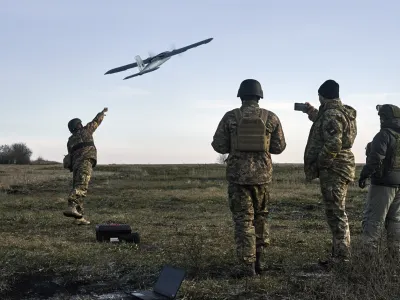 Ukrainian soldiers launch a drone at Russian positions near Bakhmut, Donetsk region, Ukraine, Thursday, Dec. 15, 2022. (AP Photo/LIBKOS)