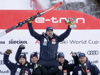 Alpine Skiing - FIS Alpine Ski World Cup - Men's Downhill - Val Gardena, Italy - December 17, 2022 Norway's Aleksander Aamodt Kilde celebrates first place on the podium with his team REUTERS/Leonhard Foeger