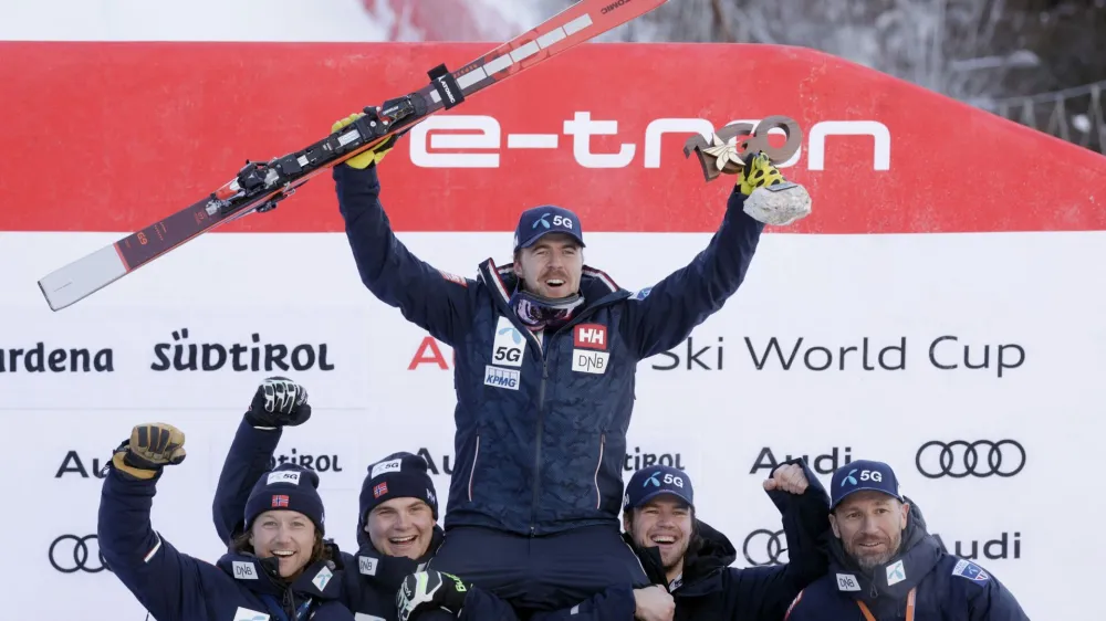 Alpine Skiing - FIS Alpine Ski World Cup - Men's Downhill - Val Gardena, Italy - December 17, 2022 Norway's Aleksander Aamodt Kilde celebrates first place on the podium with his team REUTERS/Leonhard Foeger