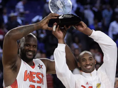 Western All-Star Shaquille O'Neal (32) of the Phoenix Suns and Western All-Star Kobe Bryant (24) of the Los Angeles Lakers share the MVP award from the NBA All-Star basketball game Sunday, Feb. 15, 2009, in Phoenix. (AP Photo/Ross D. Franklin)