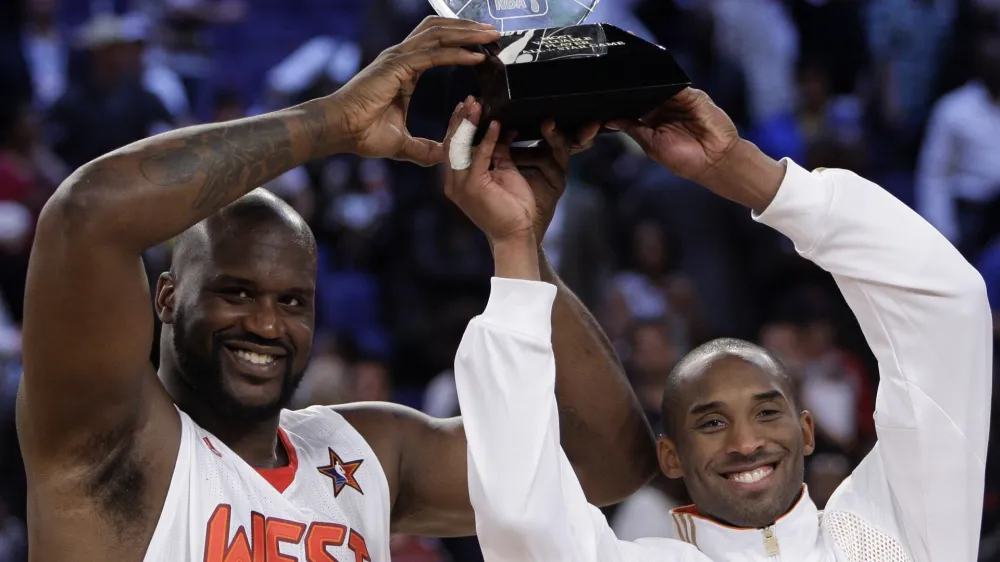 Western All-Star Shaquille O'Neal (32) of the Phoenix Suns and Western All-Star Kobe Bryant (24) of the Los Angeles Lakers share the MVP award from the NBA All-Star basketball game Sunday, Feb. 15, 2009, in Phoenix. (AP Photo/Ross D. Franklin)