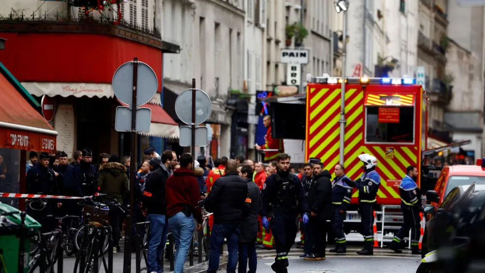 French police and firefighters secure a street after gunshots were fired killing two people and injuring several in a central district of Paris, France, December 23, 2022. REUTERS/Sarah Meyssonnier