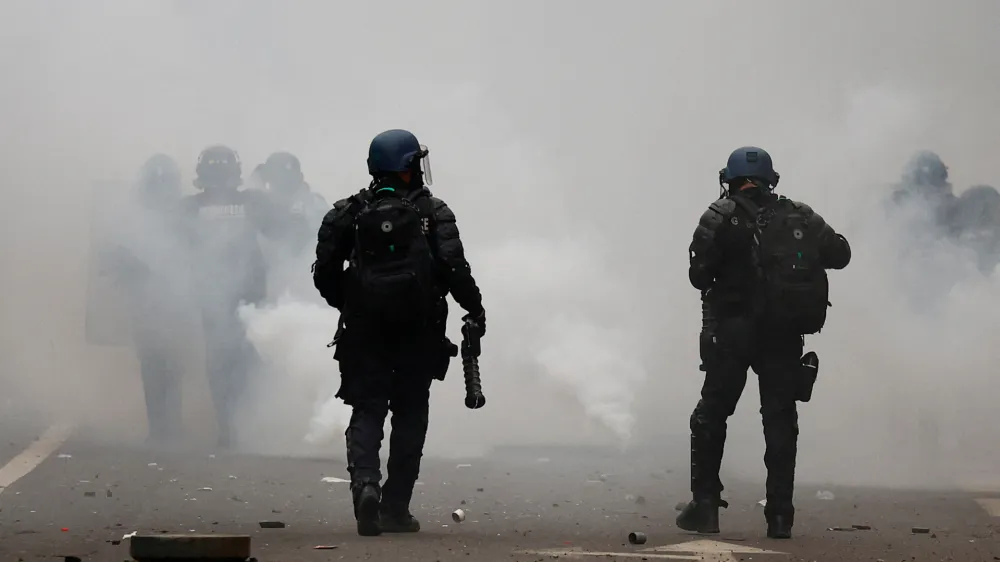 A Gendarmerie officer holds an LBD (defensive ball launcher) weapon, as members of the Kurdish community attend a demonstration, following a shooting, in Paris, France December 24, 2022. REUTERS/Sarah Meyssonnier