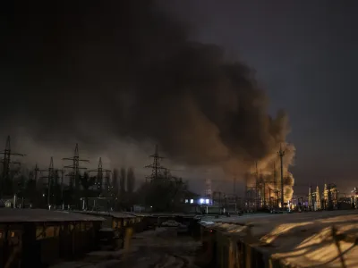 Smoke billows from a power infrastructure following a Russian drone attack in Kyiv region, Ukraine, Monday, Dec. 19, 2022. In recent months, Russia began targeting the energy infrastructure aiming to cut electricity and heating to Ukrainians, as the freezing winter advances. (AP Photo/Felipe Dana)