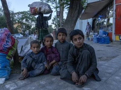 Afghankids beg on a side walk in Kabul, Afghanistan, Tuesday, May 24, 2022. Afghanistan is expected 1.1 million children under the age of 5 will face malnutrition in the country by the end of this year, as hospitals wards are packed with sick children for sever hunger and malnutrition. (AP Photo/Ebrahim Noroozi)