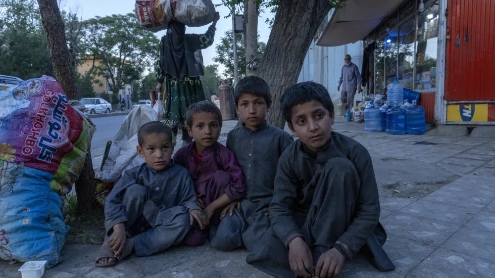 Afghankids beg on a side walk in Kabul, Afghanistan, Tuesday, May 24, 2022. Afghanistan is expected 1.1 million children under the age of 5 will face malnutrition in the country by the end of this year, as hospitals wards are packed with sick children for sever hunger and malnutrition. (AP Photo/Ebrahim Noroozi)