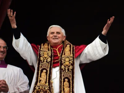 Pope Benedict XVI greets the crowd from the central balcony of St. Peter's Basilica at the Vatican, Tuesday, April 19, 2005. Joseph Ratzinger of Germany, who chose the name of Pope Benedict XVI, is the 265th pontiff of the Roman Catholic Church. (AP Photo/Domenico Stinellis)