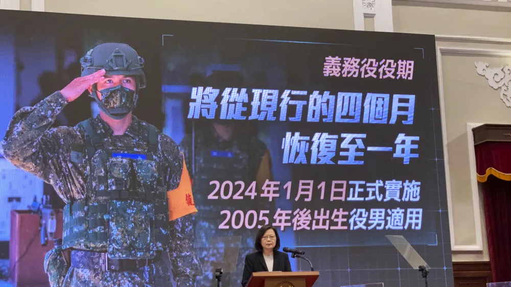 Taiwanese President Tsai Ing-wen speaks during an announcement of the extension of the island's compulsory military service in Taipei, Taiwan on Tuesday, Dec. 27, 2022. Taiwan will extend its compulsory military service from four months to a year starting in 2024, President Tsai Ing-wen said Tuesday, as the self-ruled island faces China's military, diplomatic and trade pressure. Words on display reads, "Compulsory Military Service: Will extend the current fourth months to return to a year." (AP Photo/Huizhong Wu)