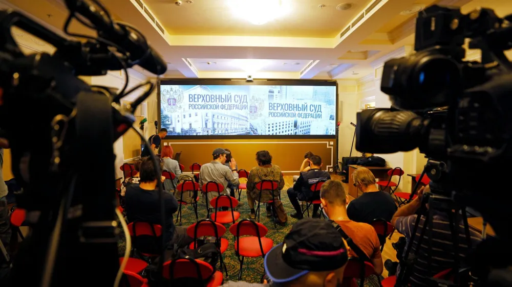 Journalists gather in front of a screen in a room of Russia's Supreme Court before a hearing on whether to designate Ukraine's Azov Regiment as a terrorist entity in Moscow, Russia August 2, 2022. REUTERS/Maxim Shemetov