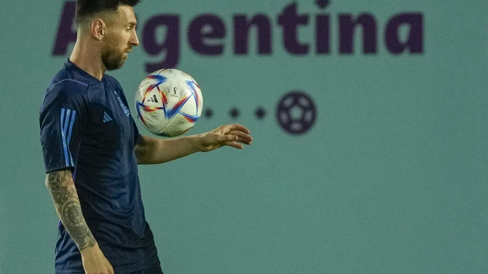 Argentina's Lionel Messi controls a ball during a training session on the eve of the round of sixteen World Cup soccer match between Argentina and Australia, in Doha, Qatar, Friday, Dec. 2, 2022. (AP Photo/Jorge Saenz)