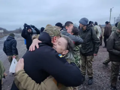 A woman embraces a Ukrainian prisoner of war (POWs) after a swap, amid Russia's attack on Ukraine, in an unknown location, Ukraine December 31, 2022. Head of Ukraine's Presidential Office Andriy Yermak via Telegram/Handout via REUTERS ATTENTION EDITORS - THIS IMAGE HAS BEEN SUPPLIED BY A THIRD PARTY. NO RESALES NO ARCHIVE.