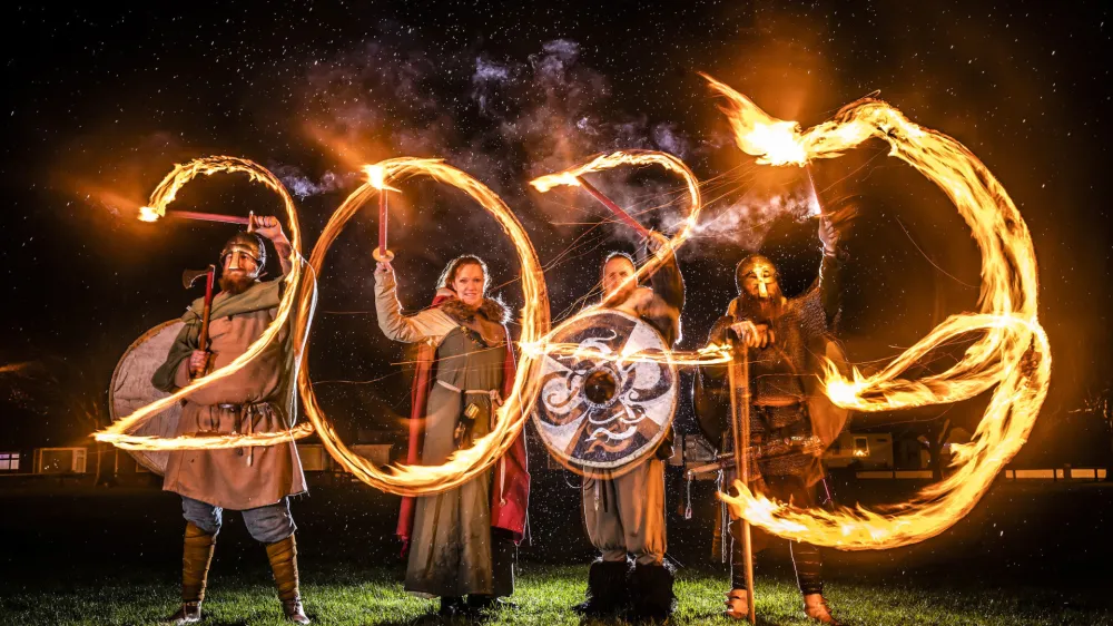 Viking reenactors use flaming torches to write 2023 at the Flamborough Fire Festival, a Viking themed parade in aid of charities and local community groups, held on New Year's Eve in Flamborough near Bridlington, England, Saturday Dec. 31, 2022. (Danny Lawson/PA via AP)