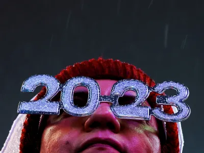 A reveller wearing glasses stands in the rain in Times Square during the first New Year's Eve event without restrictions since the coronavirus disease (COVID-19) pandemic in the Manhattan borough of New York City, New York, U.S., December 31, 2022. REUTERS/Andrew Kelly - RC2DHY9508FG