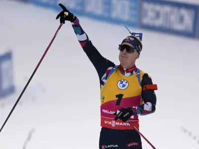 Johannes Thingnes Boe, of Norway, celebrates as he crosses the finish line to win the men 12.5 km pursuit competition at the Biathlon World Cup event in Pokljuka, Slovenia, Saturday, Jan. 7, 2023. (AP Photo/Darko Bandic)