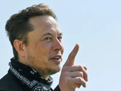 FILE PHOTO: Tesla CEO Elon Musk gestures as he visits the construction site of Tesla's Gigafactory in Gruenheide near Berlin, Germany, August 13, 2021. Patrick Pleul/Pool via Reuters/File Photo