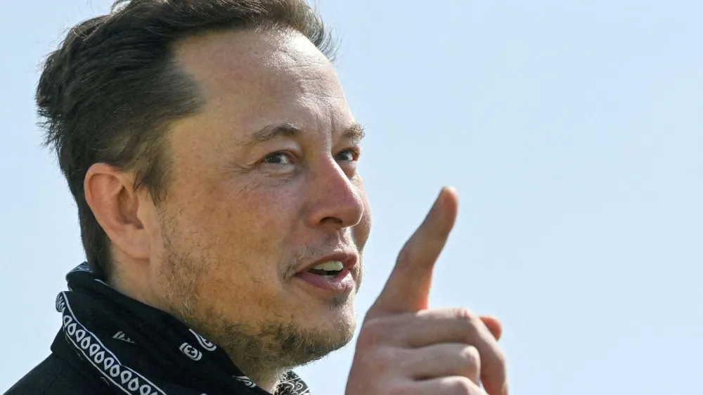 FILE PHOTO: Tesla CEO Elon Musk gestures as he visits the construction site of Tesla's Gigafactory in Gruenheide near Berlin, Germany, August 13, 2021. Patrick Pleul/Pool via Reuters/File Photo