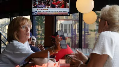 A television in a restaurant shows the news after reports of multiple shots fired and apparent injuries to Republican presidential candidate former U.S. President Donald Trump at his rally in Pennsylvania, outside the site of the 2024 Republican National Convention in Milwaukee, Wisconsin, U.S., July 13, 2024. REUTERS/Brian Snyder