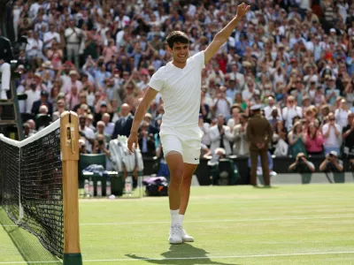 Tennis - Wimbledon - All England Lawn Tennis and Croquet Club, London, Britain - July 14, 2024 Spain's Carlos Alcaraz celebrates after winning the men's singles final against Serbia's Novak Djokovic REUTERS/Paul Childs