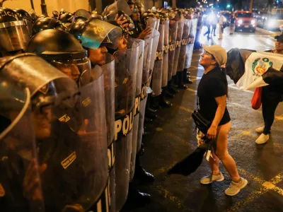 A demonstrator reacts before security forces as people protest demanding the dissolution of Congress and democratic elections, in rejection of Dina Boluarte as Peru's president, after the ouster of leftist President Pedro Castillo, in Lima, Peru January 12, 2023. REUTERS/Sebastian Castaneda