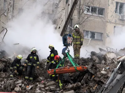 15 January 2023, Ukraine, Dnipro: Rescuers remove the rubble and search for survivors at an apartment block hit by Russian rockets during a massive missile attack on Dnipro. Photo: -/Ukrinform/dpa