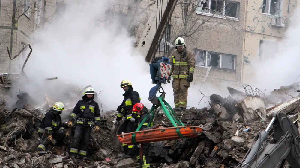 15 January 2023, Ukraine, Dnipro: Rescuers remove the rubble and search for survivors at an apartment block hit by Russian rockets during a massive missile attack on Dnipro. Photo: -/Ukrinform/dpa