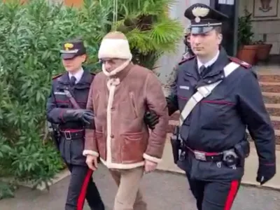 A screengrab taken from a video shows Matteo Messina Denaro the country's most wanted mafia boss being escorted out of a Carabinieri police station after he was arrested in Palermo, Italy, January 16, 2023. Carabinieri/Handout via REUTERS ATTENTION EDITORS THIS IMAGE HAS BEEN SUPPLIED BY A THIRD PARTY.