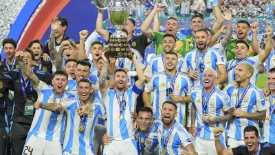 Lionel Messi hoists the trophy after Argentina defeated Colombia in the Copa America final soccer match in Miami Gardens, Fla., Monday, July 15, 2024. (AP Photo/Julio Cortez)