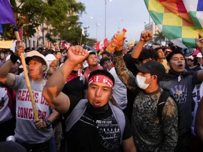 Anti-government protesters march in Lima, Peru, Saturday, Jan. 21, 2023. Protesters are seeking the resignation of President Dina Boluarte, the release from prison of ousted President Pedro Castillo and immediate elections. (AP Photo/Martin Mejia)