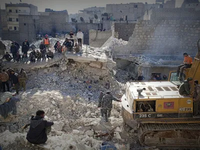 Members of a rescue team work on the scene of a residential building collapse in the Sheikh Maksoud neighbourhood of Aleppo, Syria January 22, 2023. SHAM FM/Handout via REUTERS THIS IMAGE HAS BEEN SUPPLIED BY A THIRD PARTY. MANDATORY CREDIT