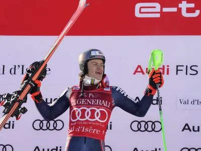 Norway's Lucas Braathen celebrates on the podium after winning an alpine ski, men's World Cup slalom, in Val D'Isere, France, Sunday, Dec.11, 2022. (AP Photo/Giovanni Auletta)