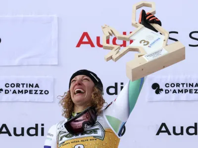 Slovenia's Ilka Stuhec celebrates on the podium after winning an alpine ski, women's World Cup downhill race, in Cortina d'Ampezzo, Italy, Saturday, Jan. 21, 2023. (AP Photo/Alessandro Trovati)