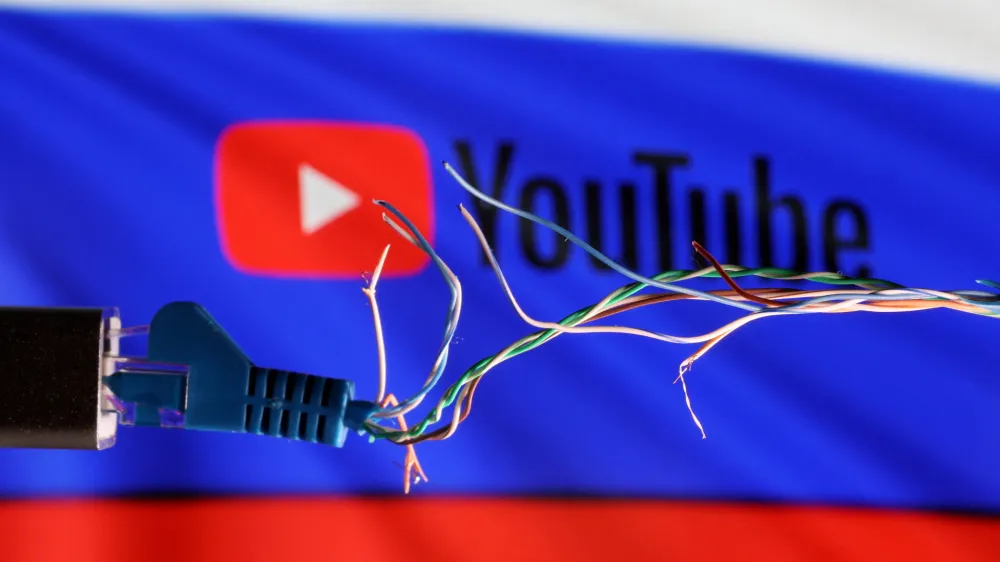 Broken Ethernet cable is seen in front of Russian flag and Youtube logo in this illustration taken March 11, 2022. REUTERS/Dado Ruvic/Illustration