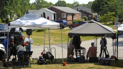 News crews line the yard of a home across the street from the home believed to be connected to the shooter in the assassination attempt of Republican presidential candidate former President Donald Trump, Monday, July 15, 2024, in Bethel Park, Pa. Investigators are hunting for any clues about what may have driven Thomas Matthew Crooks to try to assassinate Trump. (AP Photo/Gene J. Puskar)