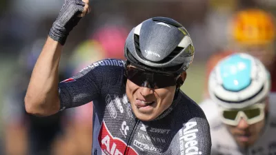 Belgium's Jasper Philipsen celebrates as he crosses the finish line ahead of Germany's Nikias Arndt, rear right, to win the sixteenth stage of the Tour de France cycling race over 188.6 kilometers (117.2 miles) with start in Gruissan and finish in Nimes, France, Tuesday, July 16, 2024. (AP Photo/Jerome Delay)