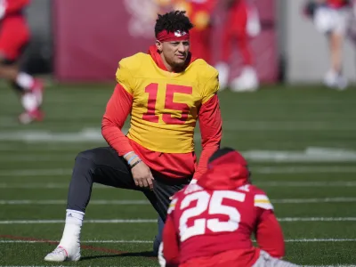 Kansas City Chiefs quarterback Patrick Mahomes (15) stretches with teammates, including running back Clyde Edwards-Helaire (25), during an NFL football practice in Tempe, Ariz., Wednesday, Feb. 8, 2023. The Chiefs will play against the Philadelphia Eagles in Super Bowl 57 on Sunday. (AP Photo/Ross D. Franklin)