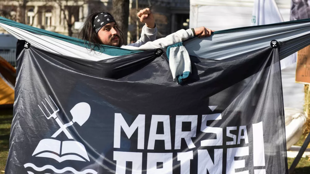 FILE PHOTO: An activist is seen in front of a banner that reads "Get off the Drina" as activists set up tents demanding ban on lithium exploitation in Belgrade, Serbia, February 11, 2022. REUTERS/Zorana Jevtic/File Photo