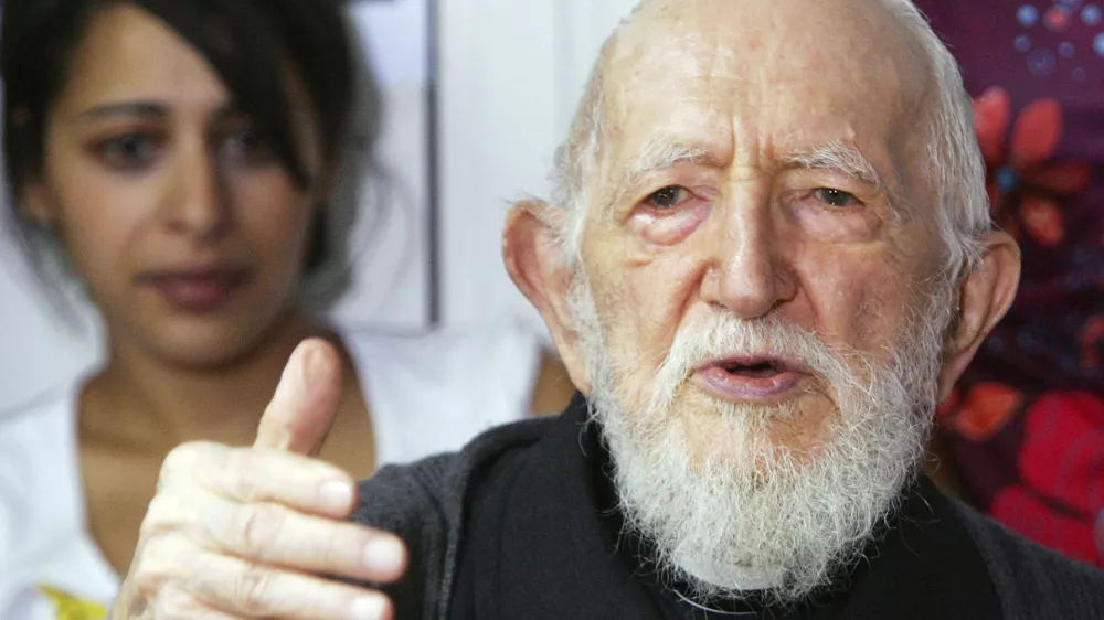 FILE - Abbe Pierre addresses journalists in his home of Alfortville, east of Paris, on Aug. 5, 2005. Several women have accused late French priest Abbe Pierre of sexual assault or harassment, his foundation said Wednesday July 17, 2024. Abbe Pierre was one of France's most beloved public figures and a lifelong advocate for the homeless. (AP Photo/Remy de la Mauviniere)