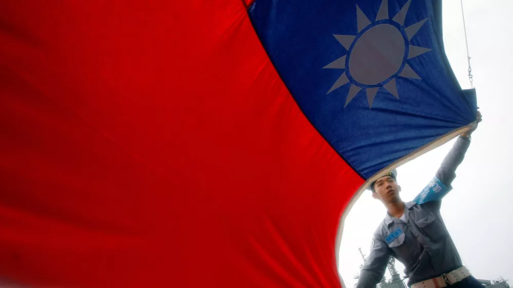 FILE PHOTO: A sailor holds a Taiwan flag on the Navy's 124th fleet Lafayette frigate during a model units tour organised by the Taiwan Ministry of National Defense, in Kaohsiung, August 28, 2008. REUTERS/Nicky Loh/File Photo