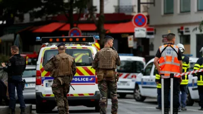 French soldiers stand at the scene after a car hit people sitting on a terrace in front of a restaurant in Paris, France July 17, 2024. REUTERS/Abdul Saboor