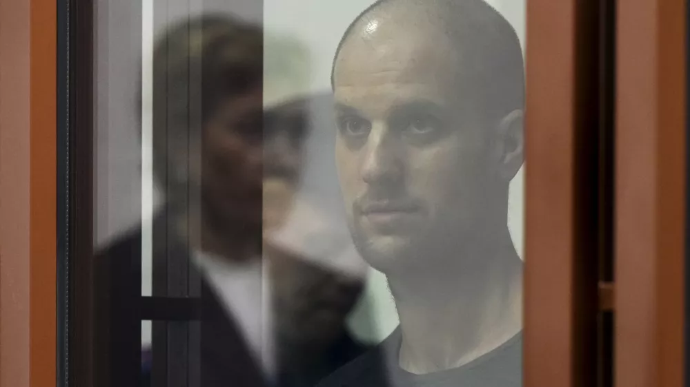 Wall Street Journal reporter Evan Gershkovich stands listening to the verdict in a glass cage of a courtroom inside the building of "Palace of justice," in Yekaterinburg, Russia, on Friday, July 19, 2024. A Russian court convicted Gershkovich on espionage charges that his employer and the U.S. have rejected as fabricated. He was sentenced to 16 years in prison after a secretive and rapid trial in the country's highly politicized legal system. (AP Photo/Dmitri Lovetsky)