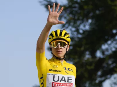 Slovenia's Tadej Pogacar, wearing the overall leader's yellow jersey, flashes five fingers for his fifth stage victory as he crosses the finish line to win the twentieth stage of the Tour de France cycling race over 132.8 kilometers (82.5 miles) with start in Nice and finish in La Couillole pass, France, Saturday, July 20, 2024. (AP Photo/Jerome Delay)