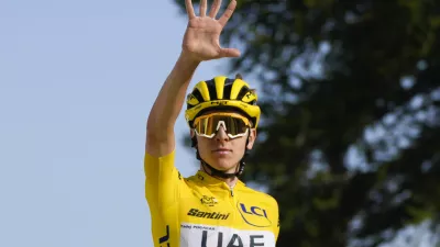 Slovenia's Tadej Pogacar, wearing the overall leader's yellow jersey, flashes five fingers for his fifth stage victory as he crosses the finish line to win the twentieth stage of the Tour de France cycling race over 132.8 kilometers (82.5 miles) with start in Nice and finish in La Couillole pass, France, Saturday, July 20, 2024. (AP Photo/Jerome Delay)