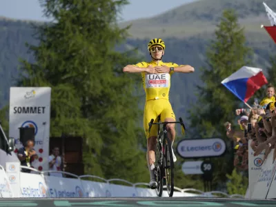 Slovenia's Tadej Pogacar, wearing the overall leader's yellow jersey, crosses the finish line to take his fifth stage win during the twentieth stage of the Tour de France cycling race over 132.8 kilometers (82.5 miles) with start in Nice and finish in La Couillole pass, France, Saturday, July 20, 2024. (AP Photo/Jerome Delay)