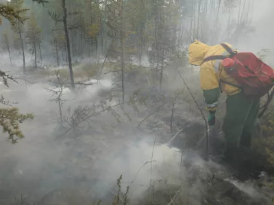 A specialist of Russia's Aerial Forest Protection Service works to extinguish a wildfire in a wood belt in the Sakha Republic, also known as Yakutia and located in the northeastern part of Siberia, Russia July 16, 2024. REUTERS/Roman Kutukov